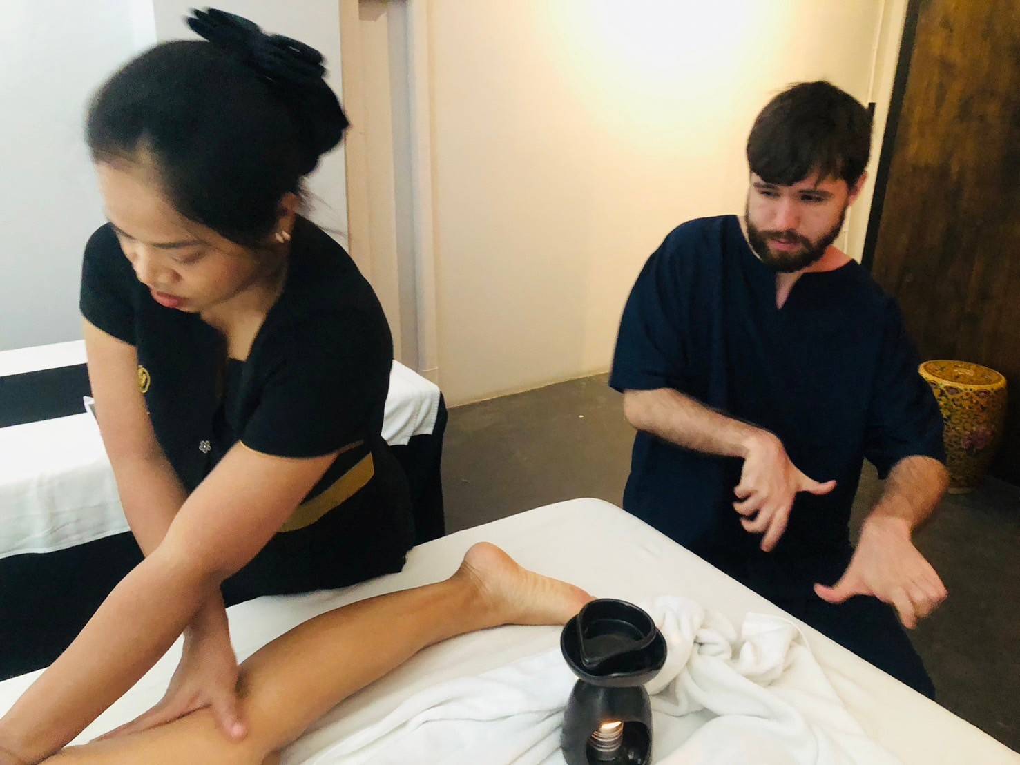 Instructor correction during oil massage training