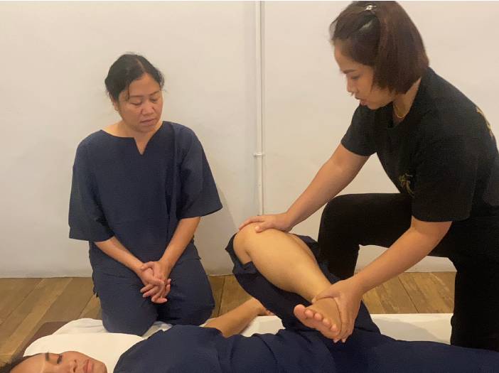 Thai massage course practice on the mat in Bangkok