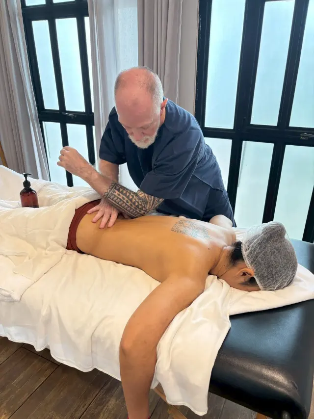 Palm pressure across the back